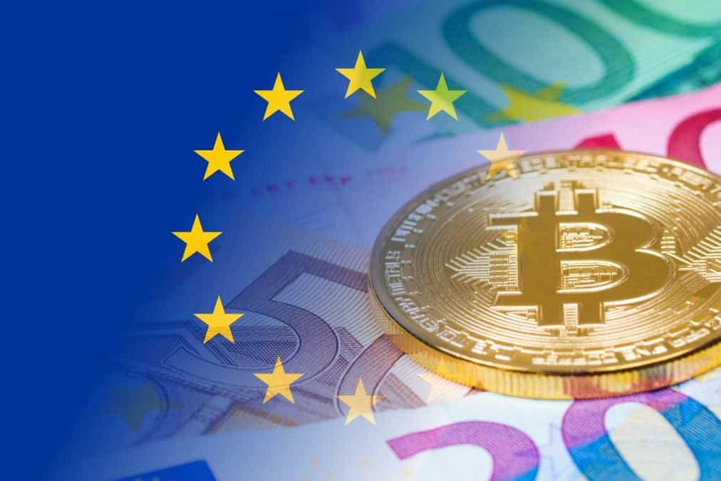 golden bitcoin metallic coin over euro banknotes with eu flag