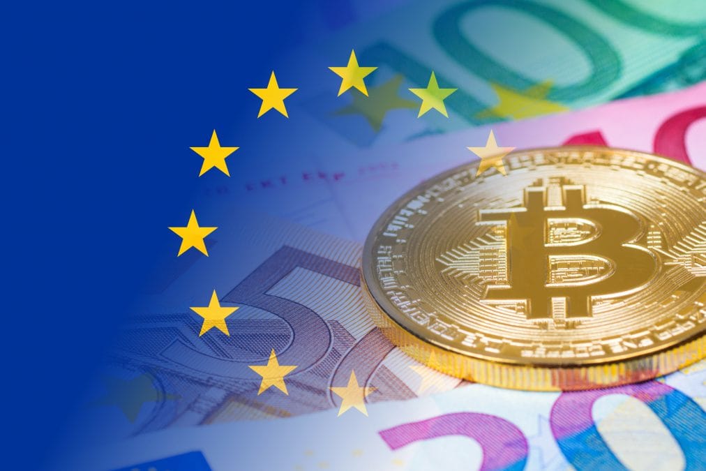 golden bitcoin metallic coin over euro banknotes with eu flag