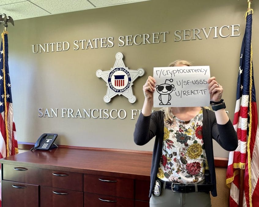 A US Secret Service agent holds a Reddit verification message.